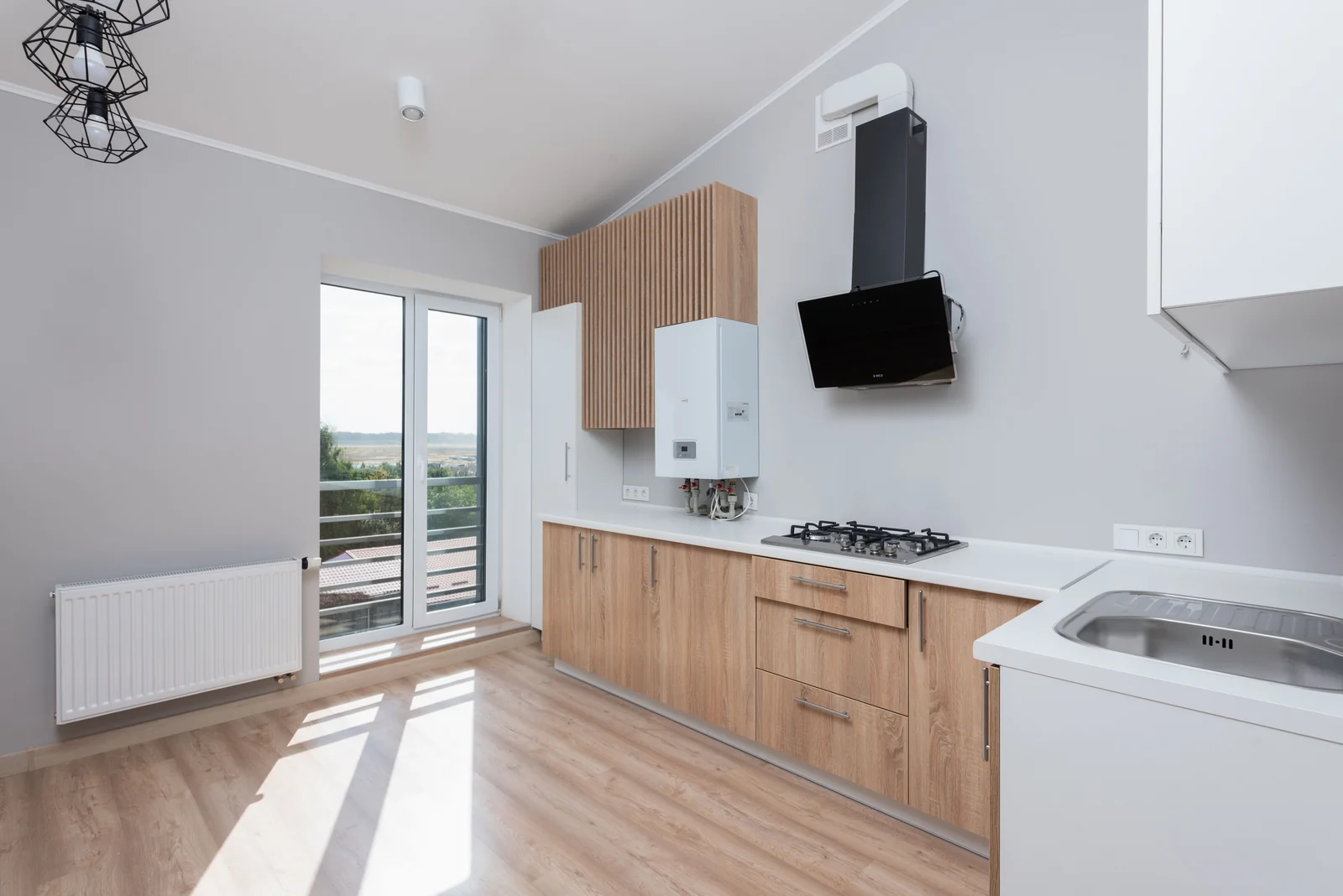 Oak slab doors with a white worktop along a single wall